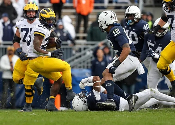 Trevor Keegan (77) and Hassan Haskins (25)