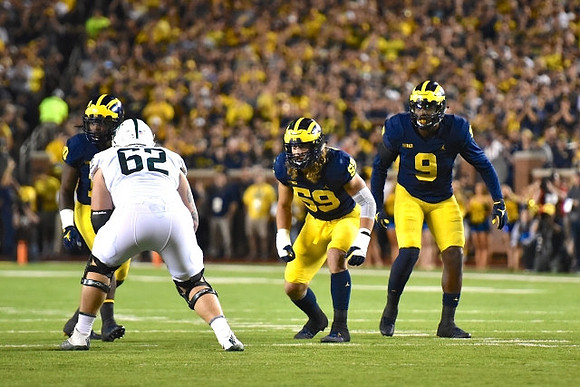 Devin Bush (10), Noah Furbush (59), and Mike McCray (9)