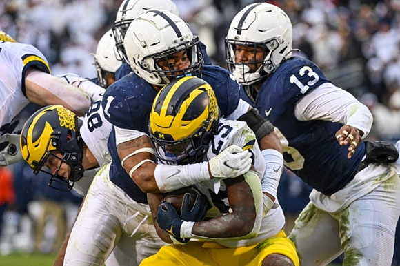 Luke Schoonmaker (86) and Hassan Haskins (25)