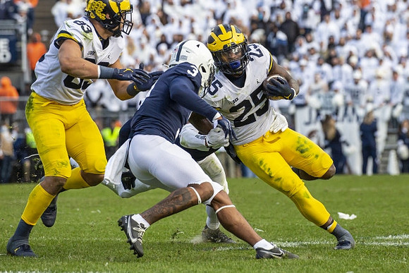 Erick All (83) and Hassan Haskins (25)