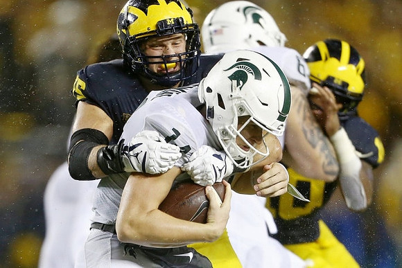Chase Winovich (15) and Devin Bush (10)