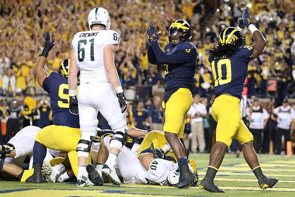 Bryan Mone (90), Mike McCray (9), and Devin Bush (10)