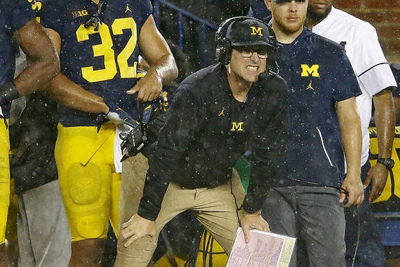 Ty Isaac (32) and Jim Harbaugh