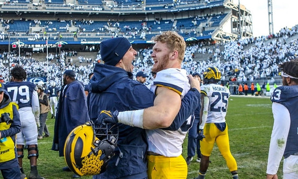 Aidan Hutchinson (97) and Hassan Haskins (25)