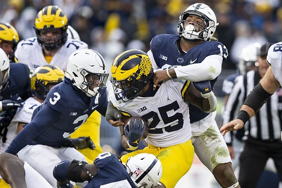 Andrew Stueber (71) and Hassan Haskins (25)