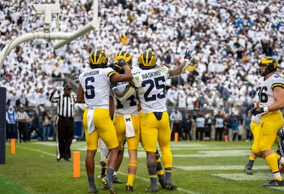 Cornelius Johnson (6), Roman Wilson (14), Hassan Haskins (25), and Luke Schoonmaker (86)