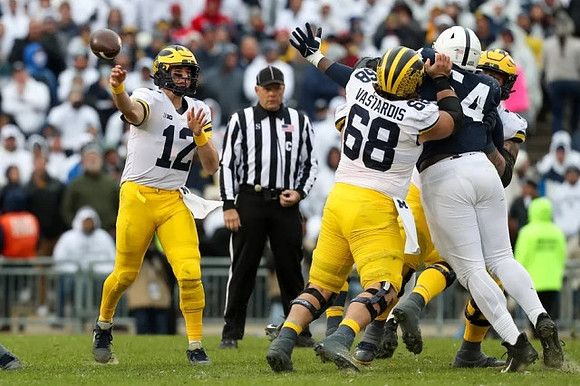 Cade McNamara (12) and Andrew Vastardis (68)