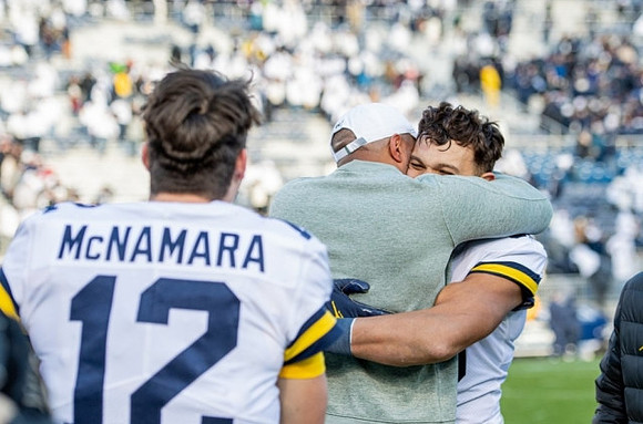 Cade McNamara (12) and Erick All (83)