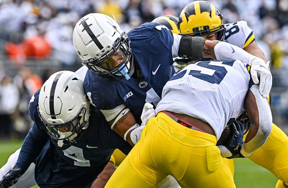Hassan Haskins (25) and Erick All (83)