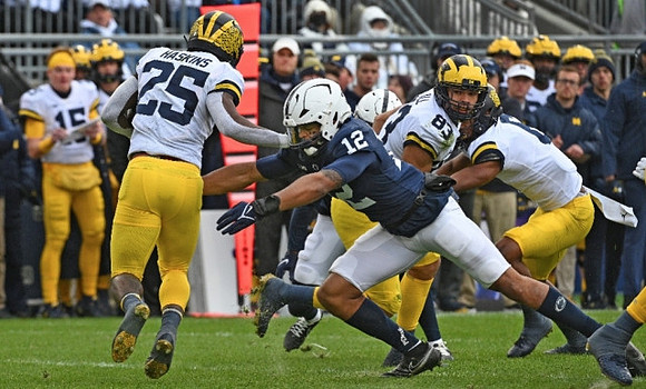 Hassan Haskins (25) and Erick All (83)