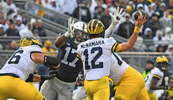Ryan Hayes (76) and Cade McNamara (12)