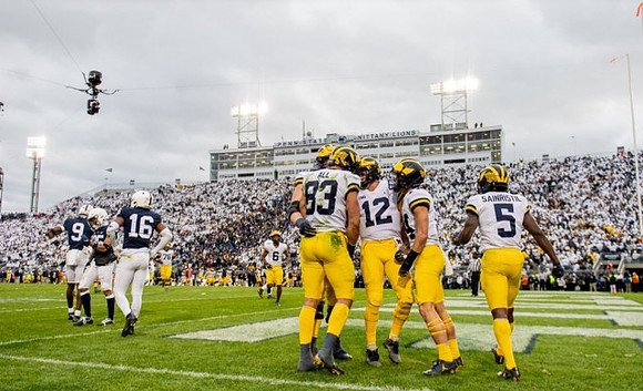 Erick All (83), Cade McNamara (12), Roman Wilson (14), and Mike Sainristil (5)