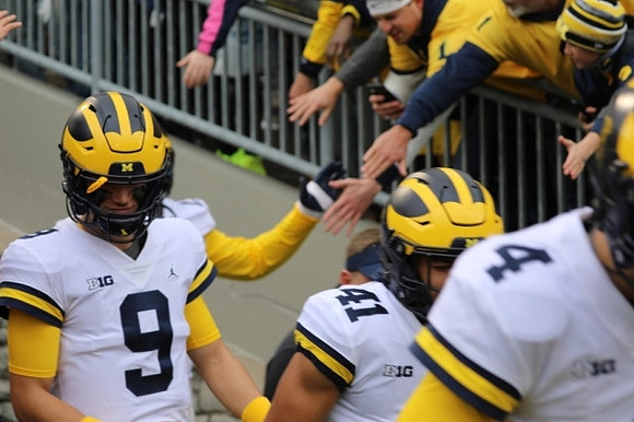 J.J. McCarthy (9), Nikhai Hill-Green (41), and Dan Villari (4)