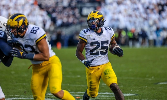 Erick All (83) and Hassan Haskins (25)