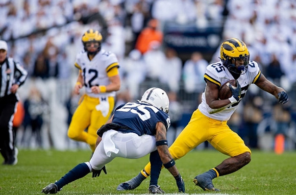 Cade McNamara (12) and Hassan Haskins (25)