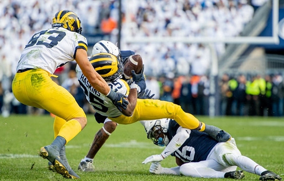 Erick All (83) and Hassan Haskins (25)