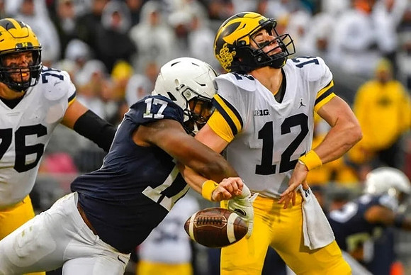 Ryan Hayes (76) and Cade McNamara (12)