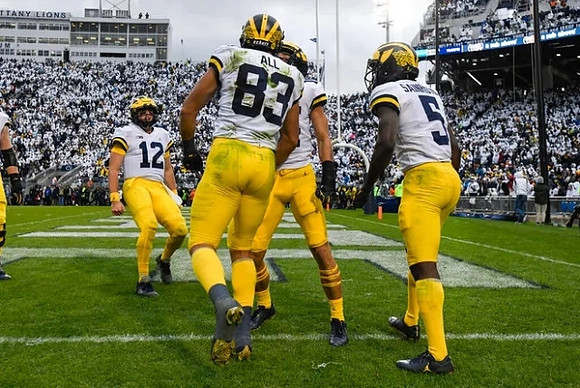 Cade McNamara (12), Erick All (83), and Mike Sainristil (5)