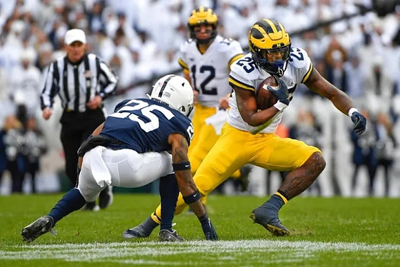 Cade McNamara (12) and Hassan Haskins (25)