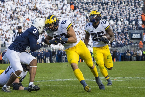 Erick All (83) and Hassan Haskins (25)
