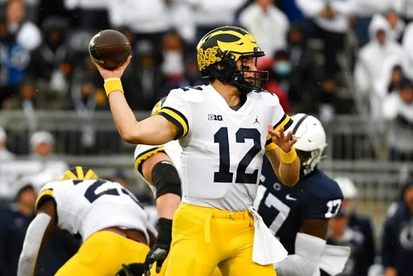 Cade McNamara (12) and Hassan Haskins (25)