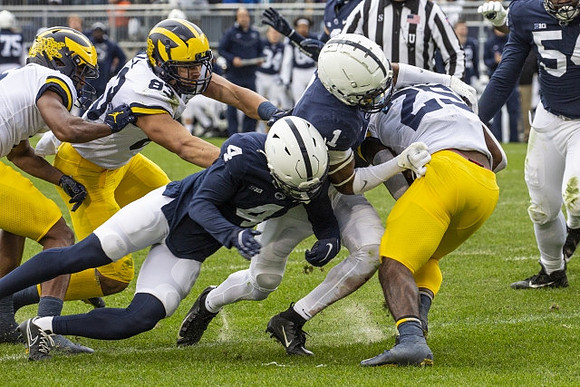 Erick All (83) and Hassan Haskins (25)