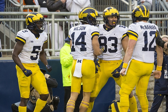 Mike Sainristil (5), Roman Wilson (14), Erick All (83), and Cade McNamara (12)