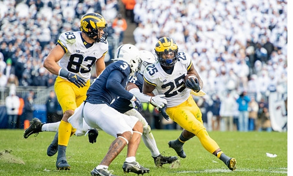 Erick All (83) and Hassan Haskins (25)
