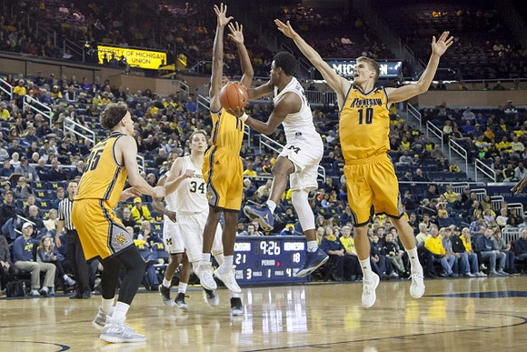 Mark Donnal (34) and Derrick Walton Jr. (10)
