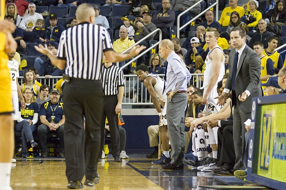 Derrick Walton Jr. (10), John Beilein, Duncan Robinson (22), and Billy Donlon