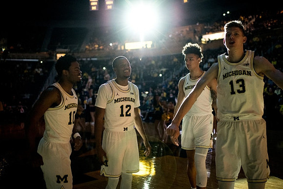 Derrick Walton Jr. (10), Muhammad-Ali Abdur-Rahkman (12), D.J. Wilson (5), and Moritz Wagner (13)