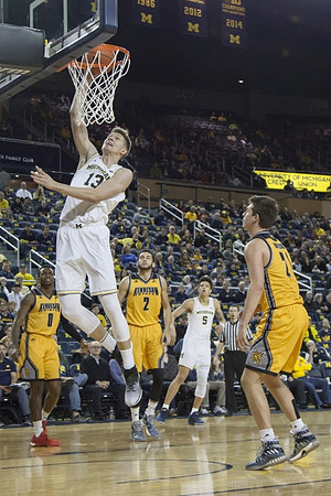 Moritz Wagner (13) and D.J. Wilson (5)