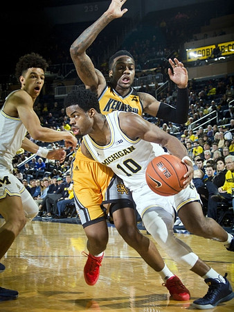 D.J. Wilson (5) and Derrick Walton Jr. (10)