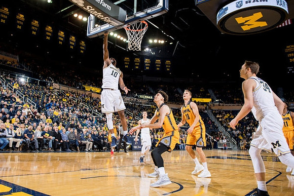 Derrick Walton Jr. (10), Duncan Robinson (22), and Mark Donnal (34)