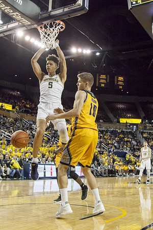D.J. Wilson (5) and Moritz Wagner (13)