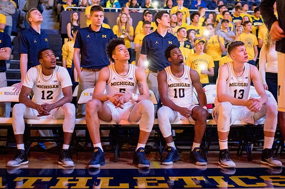 Muhammad-Ali Abdur-Rahkman (12), D.J. Wilson (5), Derrick Walton Jr. (10), and Moritz Wagner (13)