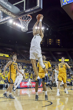 Moritz Wagner (13), D.J. Wilson (5), and Derrick Walton Jr. (10)