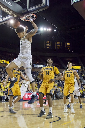Moritz Wagner (13), D.J. Wilson (5), and Derrick Walton Jr. (10)