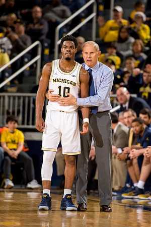 Derrick Walton Jr. (10) and John Beilein