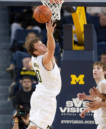 Zack Novak (0) and Evan Smotrycz (23)