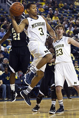 Trey Burke (3) and Evan Smotrycz (23)