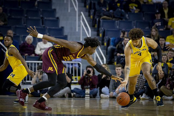 Zavier Simpson (3) and Isaiah Livers (4)