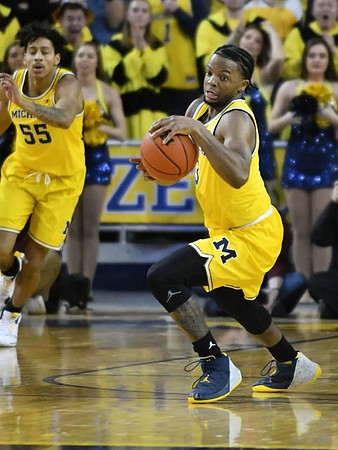 Eli Brooks (55) and Zavier Simpson (3)