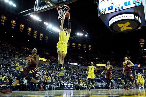 Isaiah Livers (4), Zavier Simpson (3), and Eli Brooks (55)
