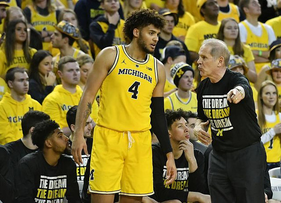 Isaiah Livers (4) and John Beilein