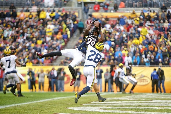 Khaleke Hudson (7) and Brandon Watson (28)
