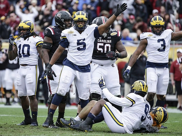 Devin Bush (10), Aubrey Solomon (5), Mike McCray (9), and Rashan Gary (3)