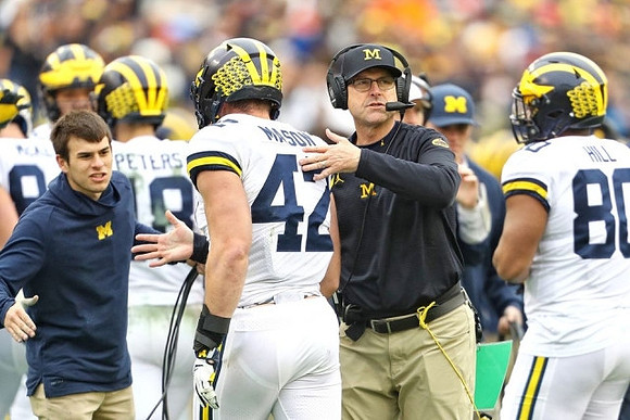 Brandon Peters (18), Ben Mason (42), Jim Harbaugh, and Khalid Hill (80)