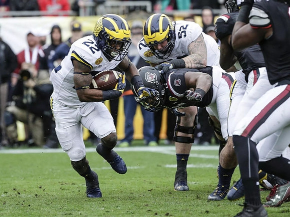 Karan Higdon (22) and Mason Cole (52)