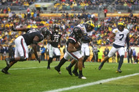 Tyree Kinnel (23) and Khaleke Hudson (7)